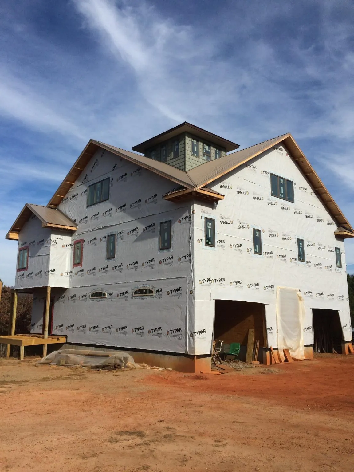 New two story house under construction with a cupola and gabled roofs in Columbus